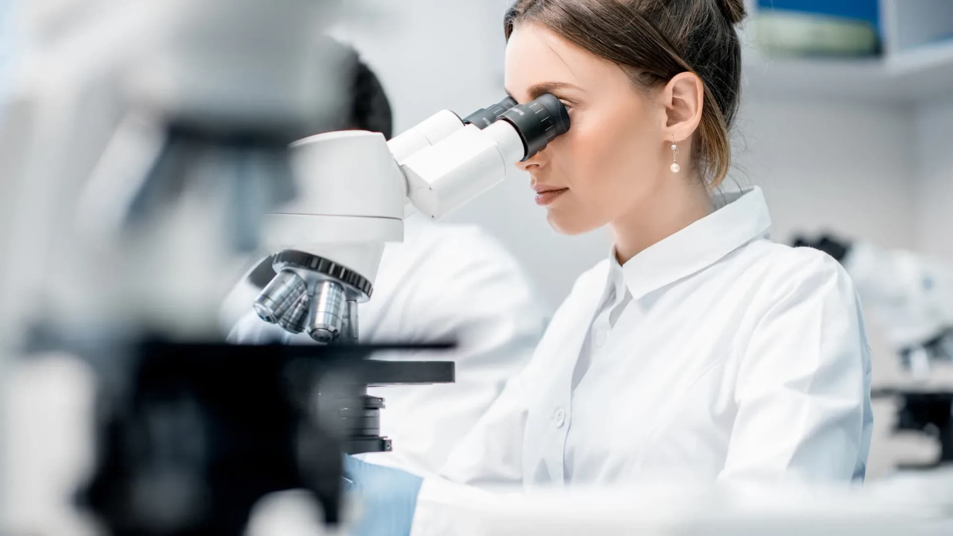 Researcher using a microscope